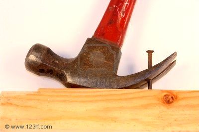 8632630_claw_hammer_removing_old_rusty_nail_from_a_board.jpg