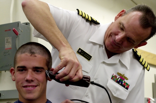 US_Navy_030701_N_0399H_006_Capt_Ralph_Scherini_gives_officer_candidate_Christopher_McCook_his_first_military_haircut_during_Induction_Day_at_the_US_Naval_Academy_USNA.jpg