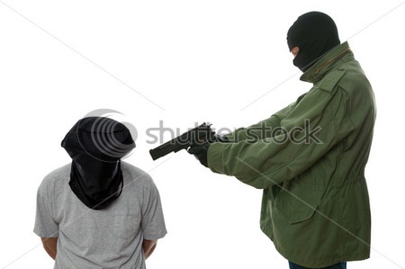 stock_photo_kidnapper_holding_a_gun_to_the_head_of_a_hooded_man_8860798.jpg
