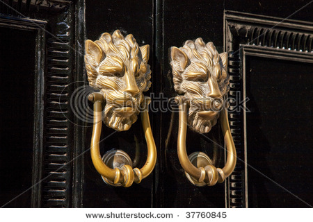 stock_photo_twin_set_of_brass_lion_head_door_knockers_london_england_uk_37760845.jpg